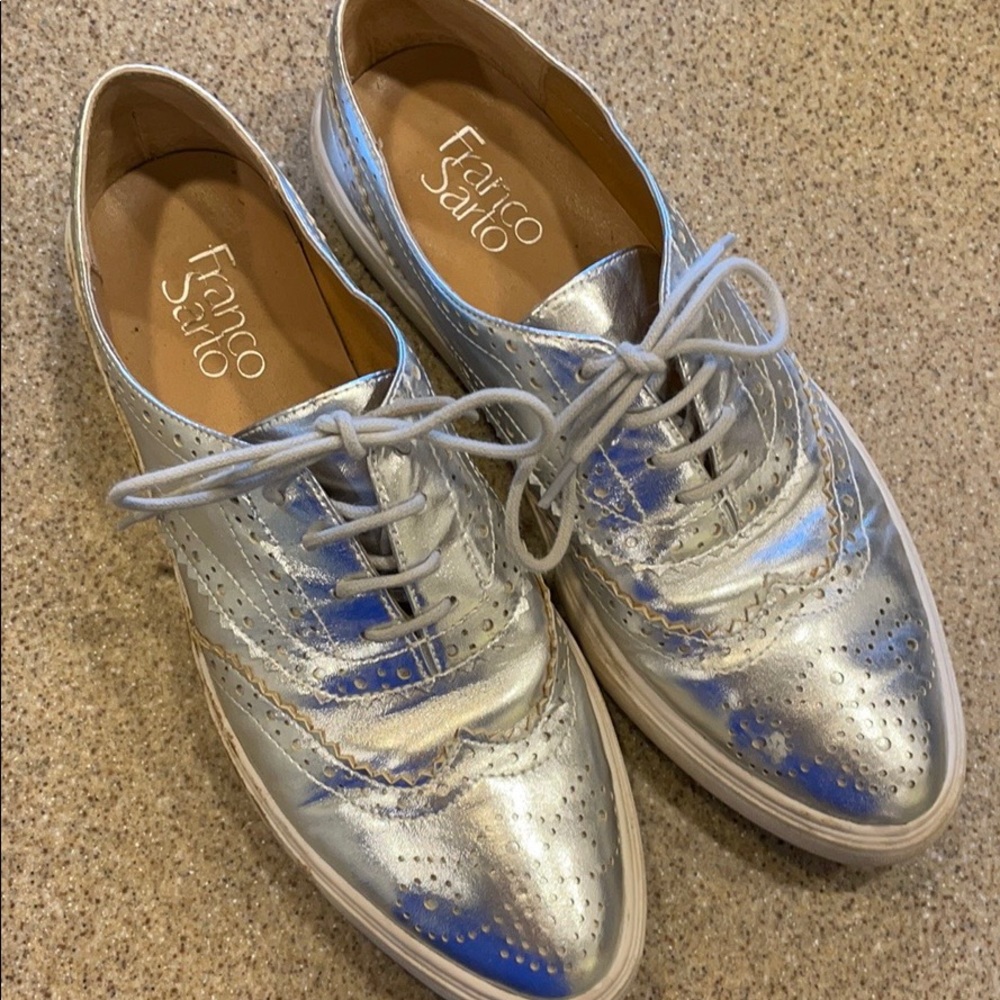 Metallic silver shoes with stain on one side